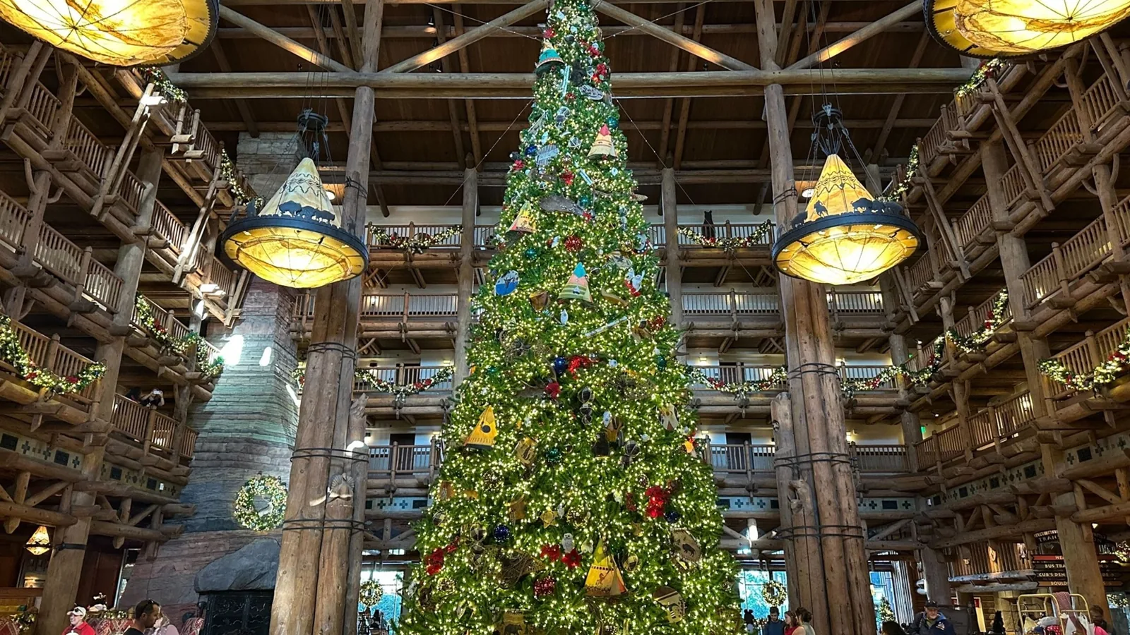 Wilderness Lodge’s soaring lobby with a giant Christmas tree and warm fireplace glow